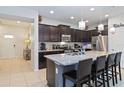 Modern kitchen features granite countertops, stainless steel appliances, and a breakfast bar at 1995 Majorca Dr, Kissimmee, FL 34747