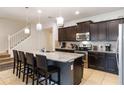 Modern kitchen features granite countertops, stainless steel appliances, and a breakfast bar at 1995 Majorca Dr, Kissimmee, FL 34747