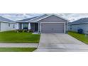 Charming one-story home featuring a well-manicured lawn and a two-car garage, with excellent curb appeal at 2059 Dexter St, Haines City, FL 33844