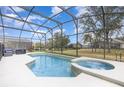 Beautiful screened-in pool and spa combination offers a relaxing outdoor experience at 2735 Lido Key Dr, Kissimmee, FL 34747