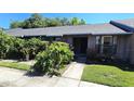 Inviting brick facade with a well-maintained lawn, lush plants, and a clear walkway to the front door at 2781 King Oak Cir, St Cloud, FL 34769