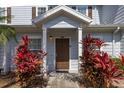 Townhouse front door with inviting covered entrance and landscaping at 2903 Edenshire Way # 103, Kissimmee, FL 34746