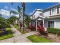 Inviting townhouse row with sidewalk and tropical landscaping in front at 2903 Edenshire Way # 103, Kissimmee, FL 34746