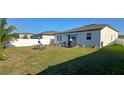Spacious backyard with a well-maintained lawn, patio area, privacy fence and outdoor seating at 2950 Scarlett Dr, St Cloud, FL 34772