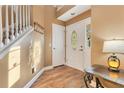 Inviting foyer with hardwood floors, white trim, and a decorative front door at 3255 Tucker Ave, St Cloud, FL 34772