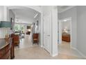 Open hallway showcasing tile flooring, neutral paint, and views into the living room and bedroom at 3421 Capland Ave, Clermont, FL 34711