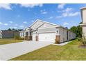 A single-Gathering home with two-car garage, set on a green lawn under a bright sky at 348 Conway Ave, St Cloud, FL 34771