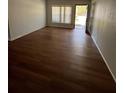 Sunlit living room with new hardwood flooring, neutral walls, and a view of the outdoors through a large window at 3503 S Crystal Lake Dr, Orlando, FL 32806