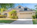 Beautiful home featuring a well-kept lawn, vibrant landscaping, and a spacious two-car garage at 506 Alleria Ct, Auburndale, FL 33823