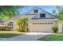 Lovely home with a neatly landscaped lawn, beautiful shrubbery, and a convenient two-car garage at 506 Alleria Ct, Auburndale, FL 33823
