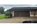 Double garage door with painted trim and exterior lighting features on a single Gathering home at 5719 Sweetheart Ct, St Cloud, FL 34772