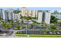 Aerial view of a condominium complex featuring a swimming pool and parking at 6165 Carrier Dr # 1603, Orlando, FL 32819