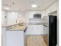 Bright kitchen featuring stainless steel appliances and granite countertops at 6165 Carrier Dr # 1603, Orlando, FL 32819
