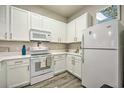 Well-lit kitchen boasting white appliances, ample cabinet space, and sleek countertop at 702 Gran Bahama Blvd, Davenport, FL 33897