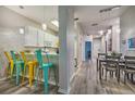 Bright living area and kitchen showcasing an open layout with contemporary finishes and colorful barstools at 702 Gran Bahama Blvd, Davenport, FL 33897