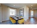 The dining room features modern table decor, window, stylish flooring, modern light fixtures and accent wall decor at 812 Lake Dell Rd, Dundee, FL 33838