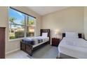 This bedroom has two twin beds, natural light from the large window, and tile flooring at 997 Lake Berkley Dr, Kissimmee, FL 34746
