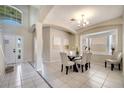 Bright dining room features tile floors, wainscoting and a picture window providing lots of natural light at 997 Lake Berkley Dr, Kissimmee, FL 34746