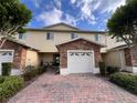 Exterior shows the home's garage with brick and stone accents, landscaping, and charming covered entryway at 10116 Shadow Leaf Ct, Orlando, FL 32825