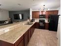 Modern kitchen features granite counters, dark cabinets, and new appliances in an open floorplan at 10116 Shadow Leaf Ct, Orlando, FL 32825