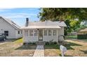 Charming single-story home with a metal roof, inviting front porch, and landscaped yard at 1018 Jersey Ave, St Cloud, FL 34769