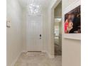 Inviting entryway with tile flooring and a decorative light fixture at 1443 Bunker Dr, Davenport, FL 33836