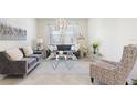 Bright living room features stylish sofas, decorative pillows and large windows at 1443 Bunker Dr, Davenport, FL 33836