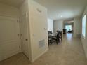 Bright dining area with tile flooring, a glass-top table set for six, and an open view to the living spaces at 1648 Heart Bar Rd, Kissimmee, FL 34744