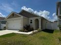 Attractive single-story house showing landscaped front yard, covered entryway, and attached two-car garage at 1648 Heart Bar Rd, Kissimmee, FL 34744