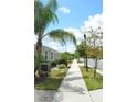 Neighborhood featuring sidewalks lined with green grass, trees, and beautifully landscaped homes at 1859 Shumard Ave, St Cloud, FL 34771