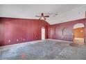 Spacious living room featuring an arched doorway and a ceiling fan at 207 Vervain Ave, Davenport, FL 33837