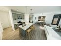 Open-concept kitchen with stainless steel appliances, island, and modern finishes at 2437 Sw 147Th Ln, Ocala, FL 34473