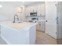 Bright kitchen with quartz countertops, stainless steel appliances, and sleek cabinetry at 2437 Sw 147Th Ln, Ocala, FL 34473