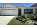 Inviting single-story home with a lovely garden and a two-car garage at 2439 White Lilly Dr, Kissimmee, FL 34747