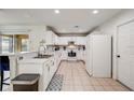 Bright kitchen featuring white cabinetry, a breakfast bar, and stainless steel appliances with natural light at 253 Granada Blvd, Davenport, FL 33837