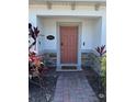 Inviting front door entrance featuring brick-paved pathway and decorative landscaping at 2883 Narcoossee Commons Way, St Cloud, FL 34771