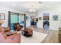 Open-concept living room with hardwood floors and plenty of natural light at 343 Scripps Ranch Rd, Poinciana, FL 34759