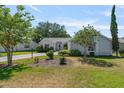 Inviting single-story residence with beautiful landscaping, a green lawn, and a paved driveway leading up to the home at 508 Alcazar Ct, The Villages, FL 32159