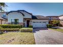 Charming single-Gathering home with well-maintained landscaping, brick driveway, and a two-car garage at 5118 Tiber Way, St Cloud, FL 34771