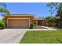 Charming single-story home with a well-manicured lawn and two-car garage at 523 Shell Creek St, Poinciana, FL 34759