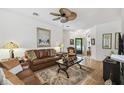 Bright living room with hard wood floors, and cozy furniture at 523 Shell Creek St, Poinciana, FL 34759