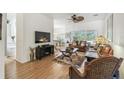 Inviting living room with hardwood floors and comfortable seating area at 523 Shell Creek St, Poinciana, FL 34759