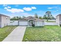 Charming single-story home featuring a well-maintained lawn and attached two-car garage at 53 Zinnia E Ln, Kissimmee, FL 34759