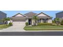 Attractive single-story home with a well-kept lawn, a two car garage, and a simple, clean landscape at 5759 Marsh Landing Dr, Winter Haven, FL 33881