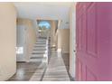 Bright foyer with neutral walls, wood-look flooring, and a staircase leading to the upper level at 638 Kangaroo Dr, Poinciana, FL 34759