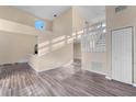 Spacious living room featuring wood-look floors, a neutral color scheme and a staircase at 638 Kangaroo Dr, Poinciana, FL 34759
