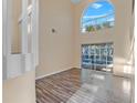 Bright living area with tall ceilings, neutral paint, wood-look floors and sliding glass doors to lanai at 638 Kangaroo Dr, Poinciana, FL 34759