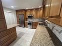 Well-lit kitchen featuring stainless steel appliances, granite countertops, and custom wood cabinetry at 664 Lake Villas Dr, Altamonte Springs, FL 32701