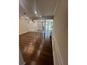 Spacious living room with wood floors and a view of the backyard and water beyond at 664 Lake Villas Dr, Altamonte Springs, FL 32701