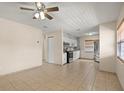 Open-concept living room with tile flooring, ceiling fan, and plenty of natural light at 704 Michigan Ct # 4, St Cloud, FL 34769